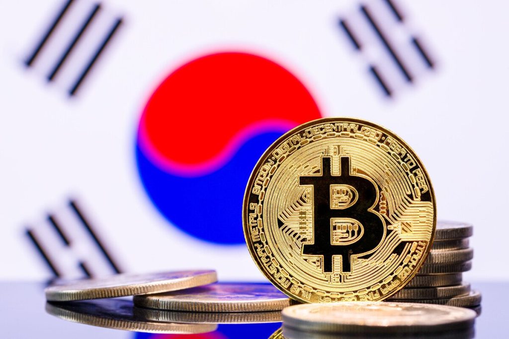 An image showing a representation of a bitcoin token against the backdrop of a South Korean flag.