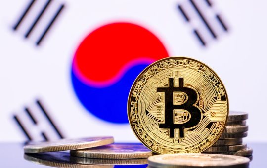 An image showing a representation of a bitcoin token against the backdrop of a South Korean flag.