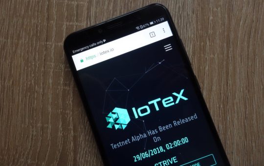 IOTX logo on a mobile phone screen